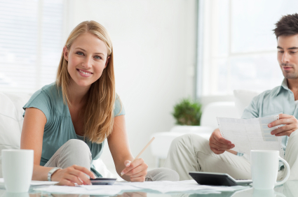 Happy young couple sorting out their home finances.