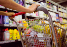 Woman,Buy,Products,With,Her,Trolley,At,Supermarket